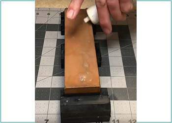 Putting water on the sharpening stone