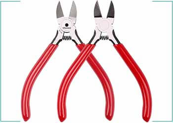 two wire cutters side by side with red handles