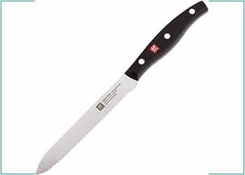 a serrated knife with a black handle