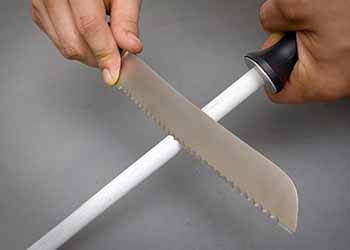 sharpening a serrated knife with a sharpening rod